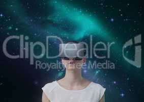 Woman in VR headset against green and purple space background