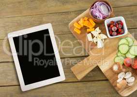Tablet on wooden desk with food 3d