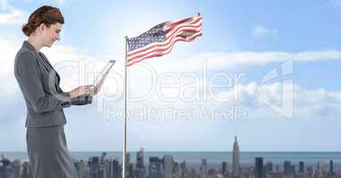 businesswoman on tablet with american flag in cityscape