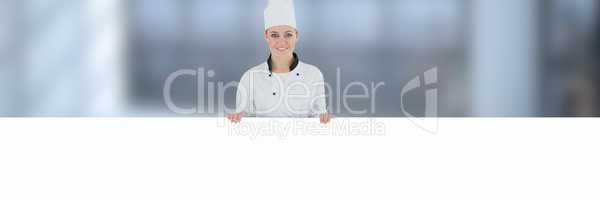 Chef holding blank sign with blurred background