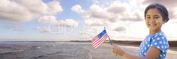 Girl with american flag against coastline