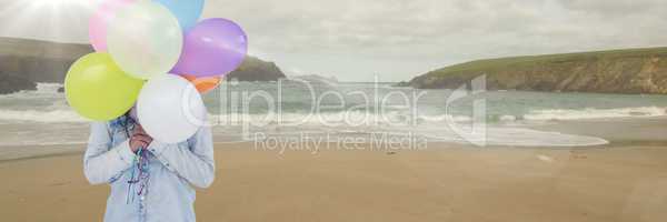 Woman mid section with balloons on beach with flare 3d