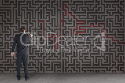 Man writing on a 3d maze background