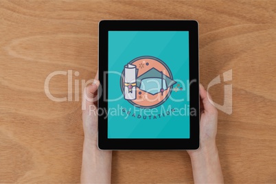 Person holding a tablet with education icon on the screen