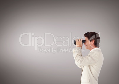 Man looking through binoculars against brown background and copy space