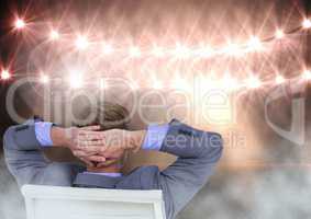 Seated man relaxed with flood lights