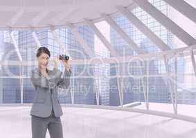 Woman with binoculars against building background