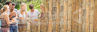 Millennials laughing and eating at bbq with wood panel transition and copy space