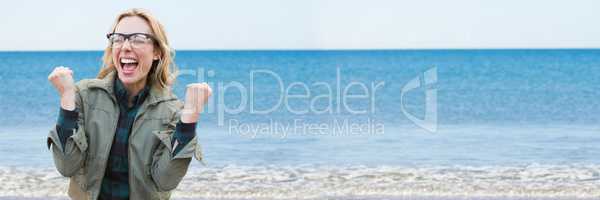 Woman in coat celebrating against blurry water 3d