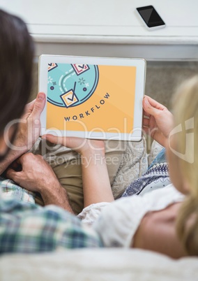 People looking at a tablet with education icon on the screen