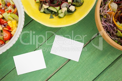 Bussiness cards on green wooden desk with food 3d