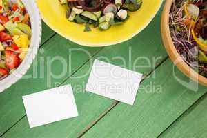 Bussiness cards on green wooden desk with food 3d