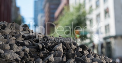 Rubble stones in city with businessman holding laptop