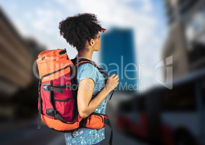 Millennial backpacker searching on blurry street