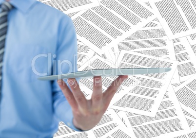 Business man mid section with tablet against document backdrop