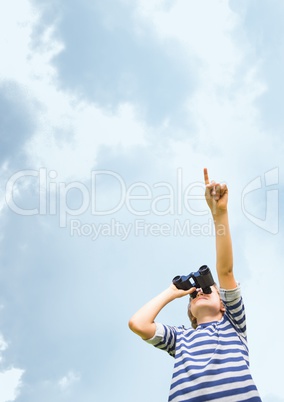 Boy looking through binoculars against sky background 3d