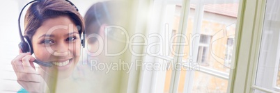 Customer service assistants with headsets  with bright window background
