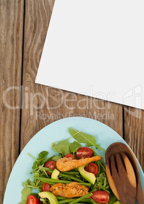 Blank card on wooden desk with food and copy space