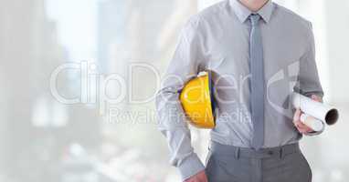 City with Architect Construction worker holding helmet and blueprints in city