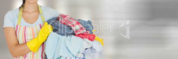 Cleaner holding laundry basket  with bright background