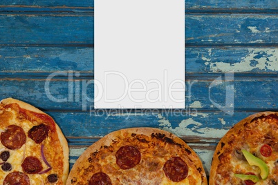 Blank card on blue wooden desk with food and copy space on paper