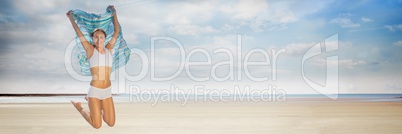 Woman in underwear with blanket celebrating on beach