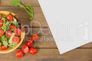 Blank card on wooden desk with food and copy space on a paper