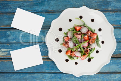 Bussiness cards on blue wooden desk with food and copy space