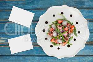 Bussiness cards on blue wooden desk with food and copy space