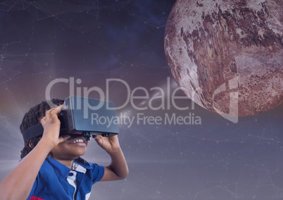 Happy boy in VR headset looking up to a 3D planet against purple background with flare