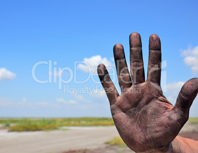 right man's hand on a background of a landscape