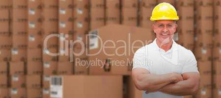 Composite image of worker wearing hard hat in warehouse