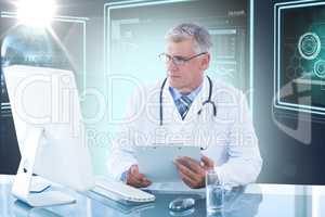 Composite 3d image of male doctor holding clipboard while looking at computer monitor