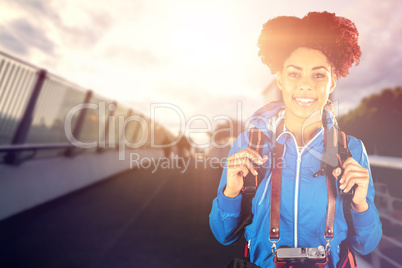 Composite image of portrait of hiker with backpack and camera