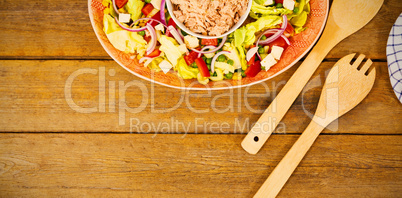 Fresh food with wooden spoon and fork on table