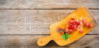 Red tomatoes on wooden cutting board