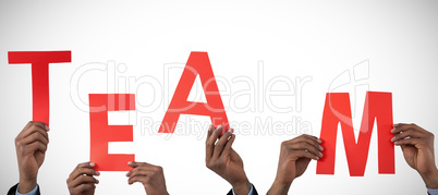 Composite image of cropped hand of businessman holding alphabet a