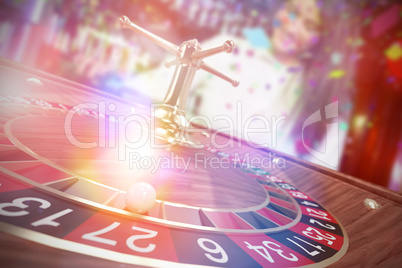 Composite image of 3d image of ball on wooden roulette wheel