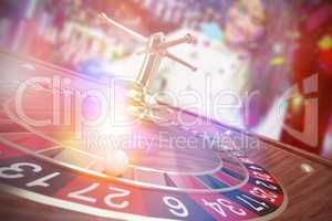 Composite image of 3d image of ball on wooden roulette wheel