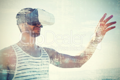 Young man using virtual reality 3d glasses at beach