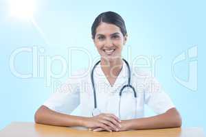 Composite 3d image of portrait of smiling female doctor sitting at desk