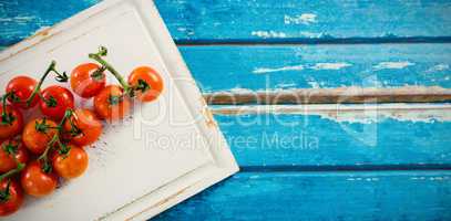 Cherry tomatoes on white cutting board