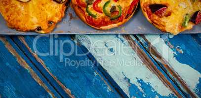 Cropped image of pizzas on weathered table