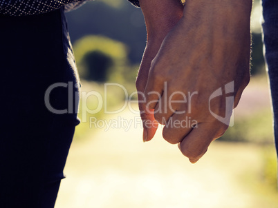 Couple holding hands close up