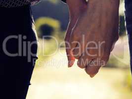 Couple holding hands close up