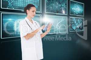 Composite 3d image of pretty nurse using tablet pc