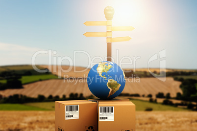 Composite image of courier with globe by road sign
