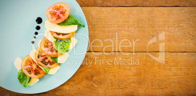 Fresh salad in plate on wooden table