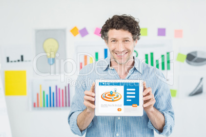 Businessman showing digital 3d tablet with blank screen in creative office