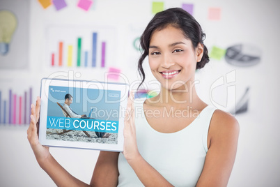 Composite 3d image of happy businesswoman showing digital tablet in creative office